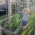 Bryson posing w/ snap pea next to tomato