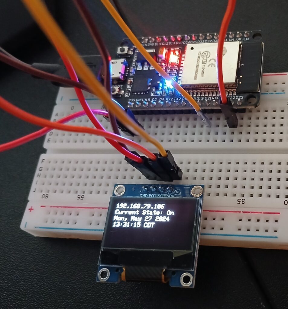 ESP32 development board mounted on breadboard with OLED 128x64 display module.